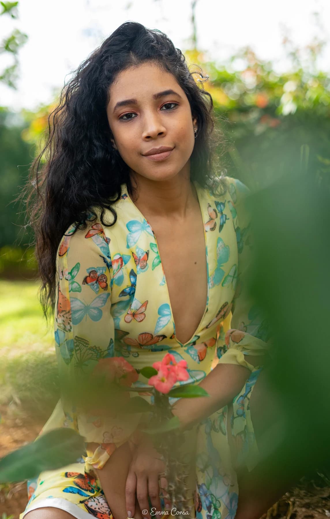 Fashion portrait in a floral outfit against a soft green background